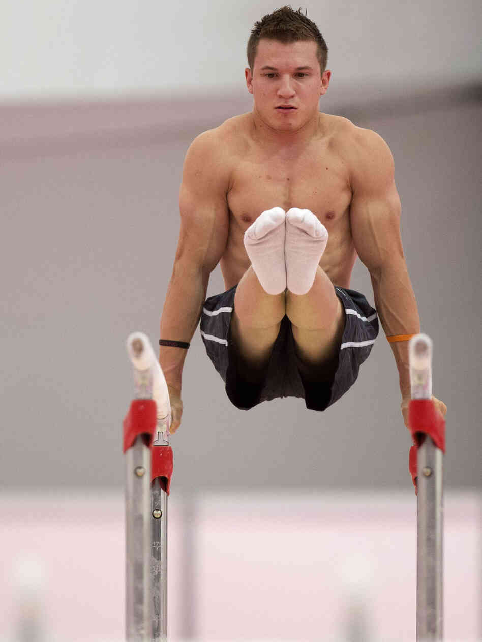 U.S. gymnast Jonathan Horton warming up on the parallel bars  in a practice arena ahead of the 2012 Summer Olympics.