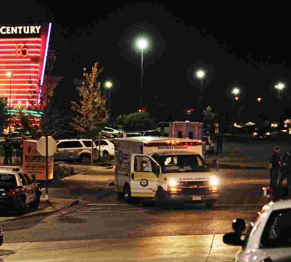 An ambulance and police cars outside the Century 16 movie theater complex in Aurora, Colo, during the early hours of July 20, 2012. A gunman attacked an audience there — killing 12 people and wounding 58.
