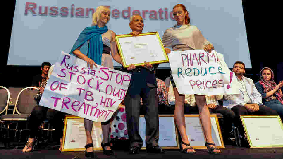 Activist Alexandra Volgina (right) accepts the Red Ribbon Award at the 19th International AIDS Conference for her grassroots group Patients in Control, which has worked to improve HIV treatment programs in Russia.