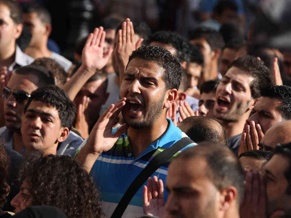 Palestinian demonstrators chant slogans in the West Bank city of Ramallah last month during a protest against a meeting between Abbas and Israel's deputy prime minister.