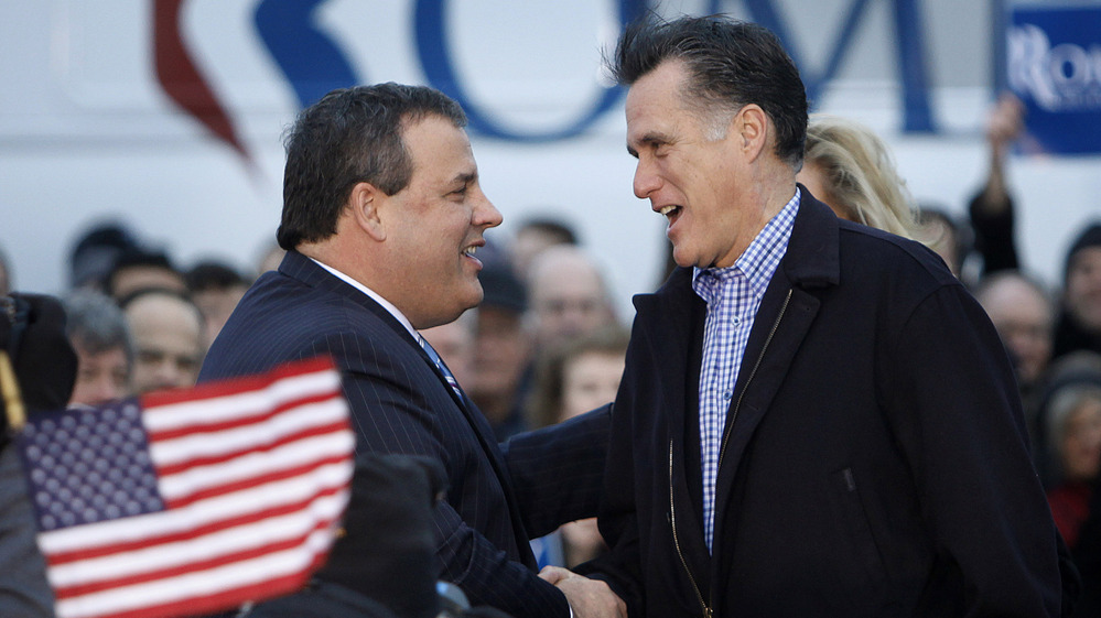 New Jersey Gov. Chris Christie greets Republican presidential candidate Mitt Romney in Des Moines, Iowa, on Dec. 30, 2011.