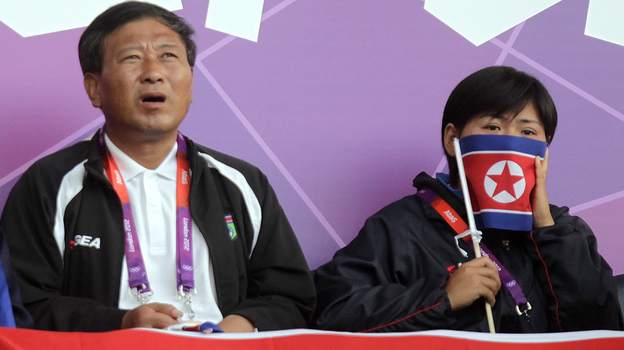 Supporters of North Korea's women's soccer team were dismayed to see the start of Wednesday's match delayed, after a video screen displayed the South Korean flag next to photos of the North Korean players.