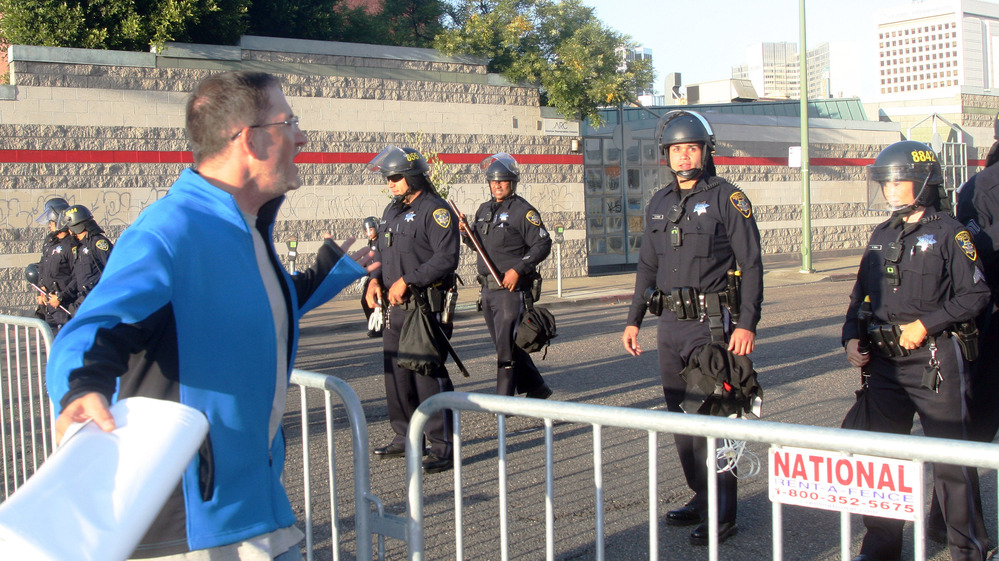 A protester yelling at a line of police officers guarding an intersection near a fundraiser for President Obama at the Fox Theater in Oakland on Monday.
