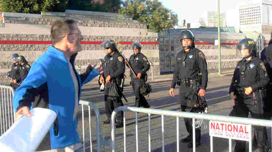 A protester yelling at a line of police officers guarding an intersection near a fundraiser for President Obama at the Fox Theater in Oakland on Monday.