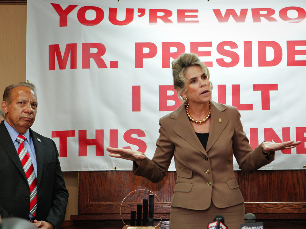 Rebecca Smith, owner of A.D. Morgan, speaks Thursday at a Tampa, Fla., event to denounce President Obama's statements about small businesses. The event was organized by the Romney campaign. At left is Lou Ramos of Value Enterprise Solutions.