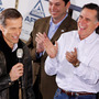 Mitt Romney gets a kick out of South Dakota Sen. John Thune's comments during a January rally in Dubuque, Iowa.