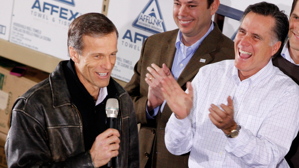 Mitt Romney gets a kick out of South Dakota Sen. John Thune's comments during a January rally in Dubuque, Iowa.