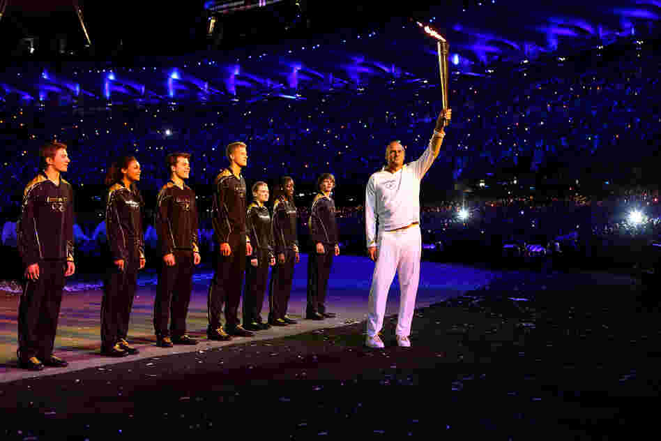 Torchbearer Sir Steve Redgrave hands the Olympic Flame over to seven young athletes who present Britain's hopes for the next Olympics.