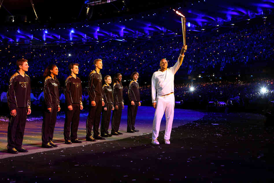 Torchbearer Sir Steve Redgrave hands the Olympic Flame over to seven young athletes who present Britain's hopes for the next Olympics.