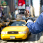 A man hails a cab in Times Square.