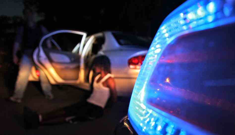 The Chicago police gang enforcement unit makes an arrest after stopping a car with four suspected gang members in June.