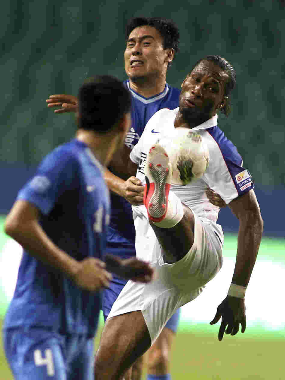 Speculation is rampant over the salary of Shanghai Shenhua's Didier Drogba, formerly with Chelsea, shown here during his Chinese Super League debut against Guangzhou Fuli in Guangzhou in southern China, July 22.