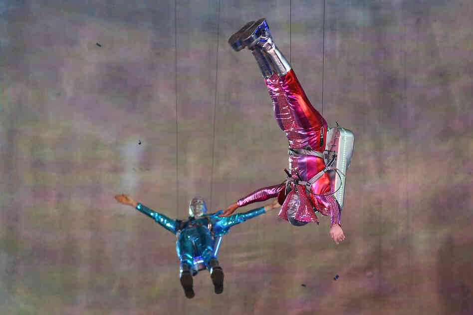 Performers with jet packs take part in the opening ceremony.