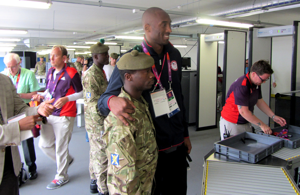 As Team USA basketball player Kobe Bryant passed through a security checkpoint Friday, British soldiers were moved to relax a ban on photography in the area.