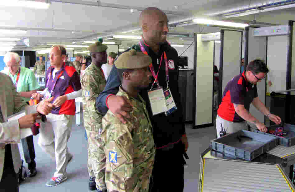 As Team USA basketball player Kobe Bryant passed through a security checkpoint Friday, British soldiers were moved to relax a ban on photography in the area.