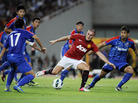 Federico Macheda of Manchester United (center) challenges players from Shanghai Shenhua during a friendly match between the two teams in Shanghai, China, on Wednesday. Federico Macheda of Manchester United (center) challenges players from Shanghai Shenhua during a friendly match between the two teams in Shanghai, China, on Wednesday.