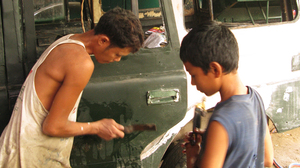 Mechanics at Ohn Myint's car repair shop on the outskirts of Yangon refurbish rusty, decades-old government jeeps.