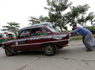 An old taxi is pushed toward a vehicle license office to be exchanged for an import permit in Yangon, Myanmar. As many Burmese citizens take cars as an investment, many imports are sold and resold with a higher markup. An old taxi is pushed toward a vehicle license office to be exchanged for an import permit in Yangon, Myanmar. As many Burmese citizens take cars as an investment, many imports are sold and resold with a higher markup.
