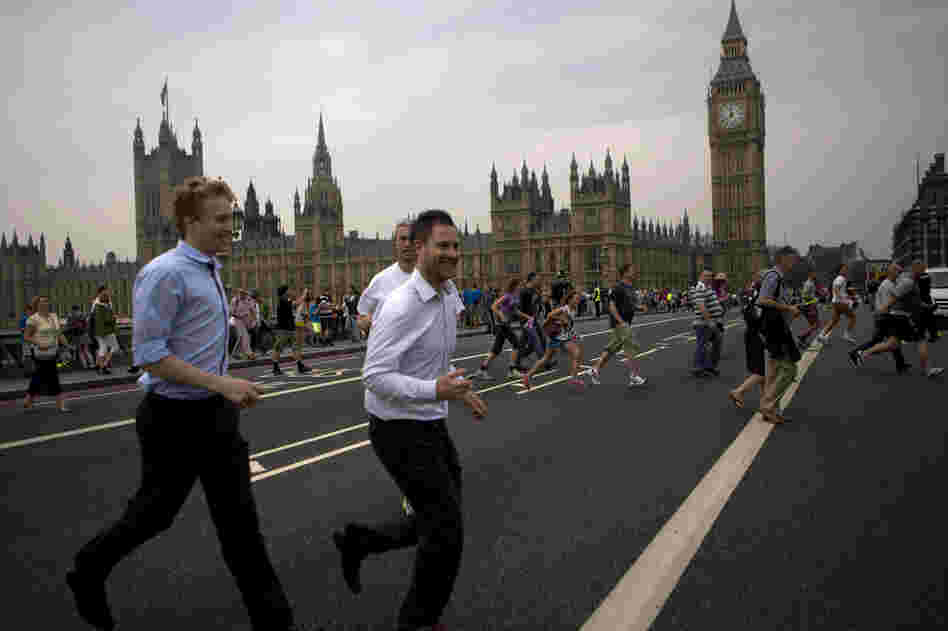 People cross the Westminster bridge to watch the Olympic flame being delivered.