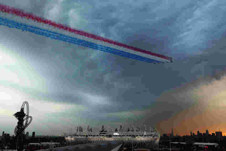 The Red Arrows, the Royal Air Force's aerobatic team, fly over the Olympic Park during the ceremony.
