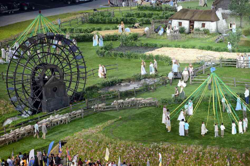 Actors perform during the British meadow scene.