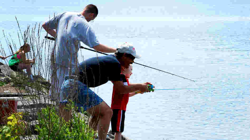 Participants in a fishing derby cast lines from a pier near Onondaga Lake's outflow in Syracuse, N.Y.