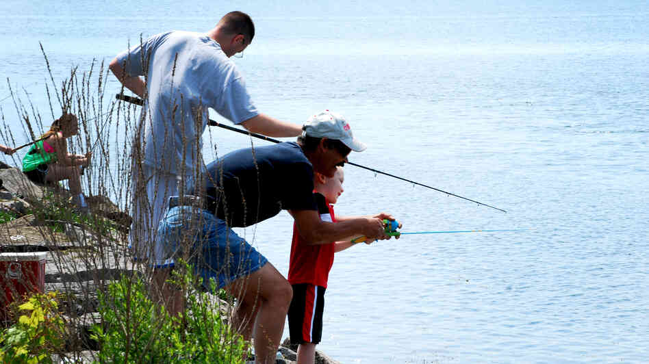 Participants in a fishing derby cast lines from a pier near Onondaga Lake's outflow in Syracuse, N.Y.