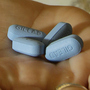 Dr. Lisa Sterman holds Truvada pills at her office in San Francisco. The drug was recently approved by the Food and Drug Administration to prevent infection in people at high risk of infection with HIV. The pill, already used to treat people with HIV, also helps reduce the odds they will spread the virus.