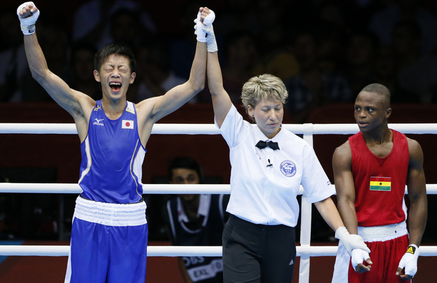 Satoshi Shimizu (left) of Japan celebrates his 10-9 points decision over Isaac Dogboe of Ghana, in their Round of 32 bantamweight bout at the 2012 London Olympic Games. The first full day of competition brought many close finishes in London.