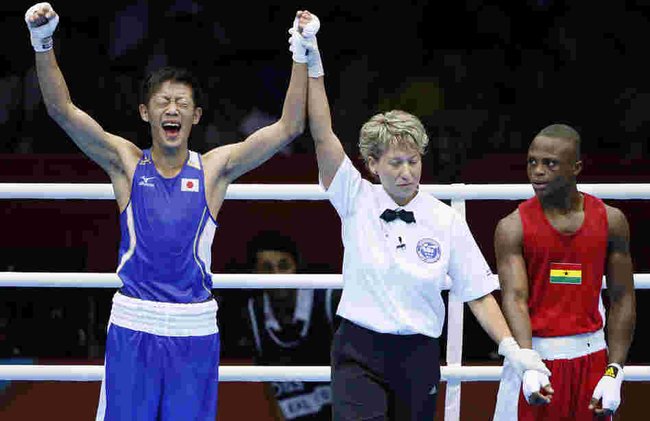 Satoshi Shimizu (left) of Japan celebrates his 10-9 points decision over Isaac Dogboe of Ghana, in their Round of 32 bantamweight bout at the 2012 London Olympic Games. The first full day of competition brought many close finishes in London.