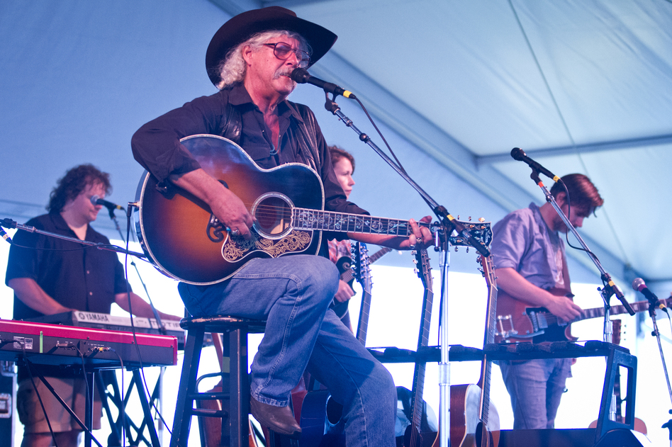 Arlo Guthrie plays with The Guthrie Family Reunion at the Newport Folk Festival moments before being surrounded by his grandchildren on stage.