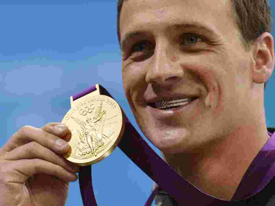 Ryan Lochte smiles on the podium with his new gold medal after winning the men's 400m individual medley in London Saturday. Lochte is wearing a dental accessory known as grillz, in the shape of the American flag. Ryan Lochte smiles on the podium with his new gold medal after winning the men's 400m individual medley in London Saturday. Lochte is wearing a dental accessory known as grillz, in the shape of the American flag.