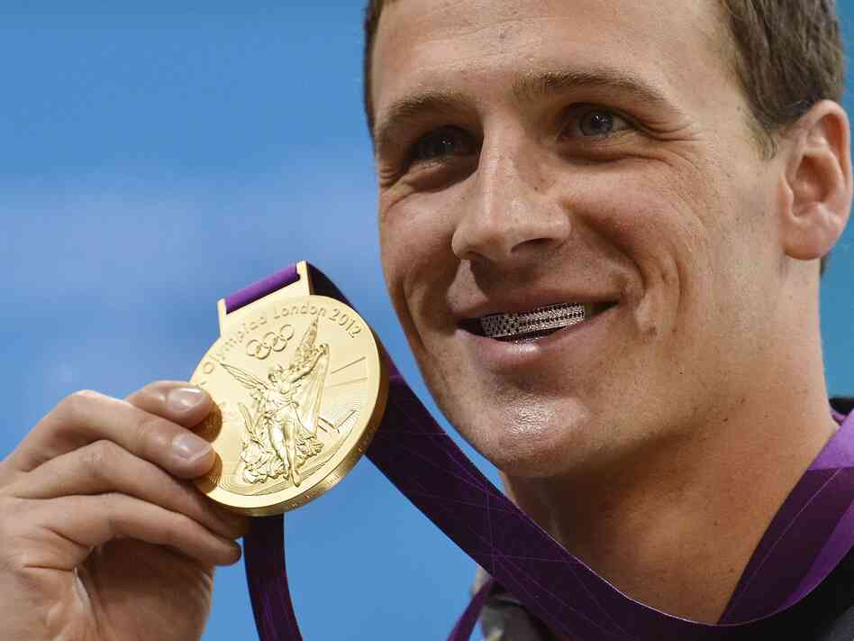 Ryan Lochte smiles on the podium with his new gold medal after winning the men's 400m individual medley in London Saturday. Lochte is wearing a dental accessory known as grillz, in the shape of the American flag. Ryan Lochte smiles on the podium with his new gold medal after winning the men's 400m individual medley in London Saturday. Lochte is wearing a dental accessory known as grillz, in the shape of the American flag.