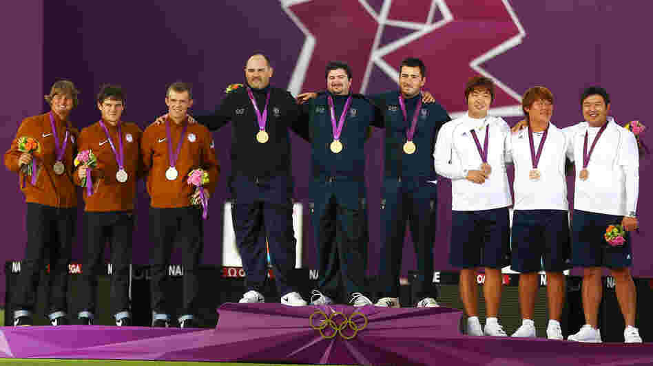 Silver medalists Brady Ellison, Jake Kaminski and Jacob Wukie of the United States, gold medalists Michele Frangilli, Marco Galiazzo and Mauro Nespoli of Italy, and bronze medalists Kim Bub-min, Im Dong-hyun and Oh Jin-hyek of South Korea stand with their medals after the men's team archery event.
