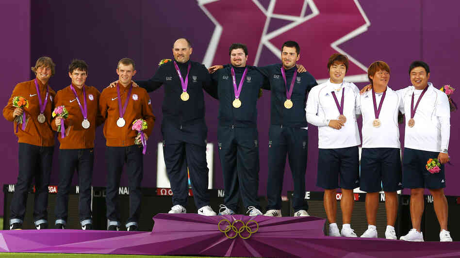 Silver medalists Brady Ellison, Jake Kaminski and Jacob Wukie of the United States, gold medalists Michele Frangilli, Marco Galiazzo and Mauro Nespoli of Italy, and bronze medalists Kim Bub-min, Im Dong-hyun and Oh Jin-hyek of South Korea stand with their medals after the men's team archery event.