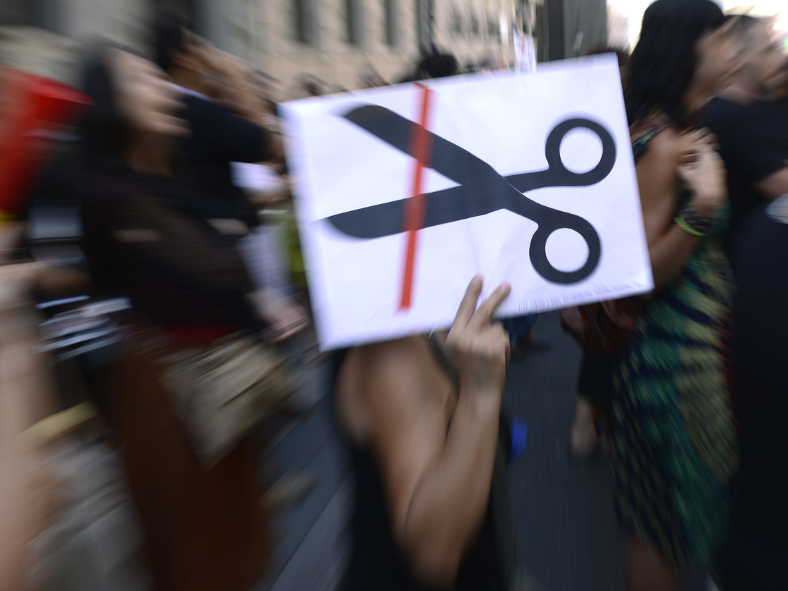 Government employees demonstrate against the Spanish government's austerity measures in Madrid, on Friday. The economic situation has forced some Spaniards to leave the country for work.