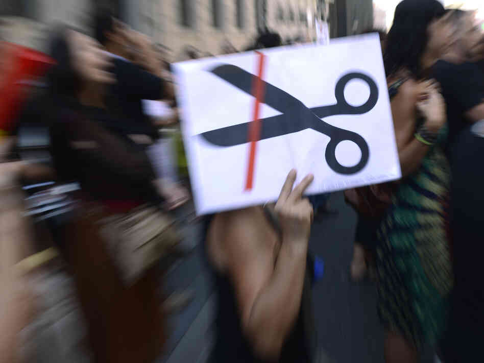 Government employees demonstrate against the Spanish government's austerity measures in Madrid, on Friday. The economic situation has forced some Spaniards to leave the country for work.