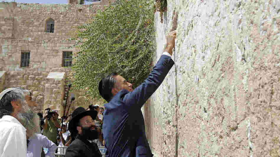 Republican presidential candidate Mitt Romney places a prayer note as he visits the Western Wall in Jerusalem on Sunday.
