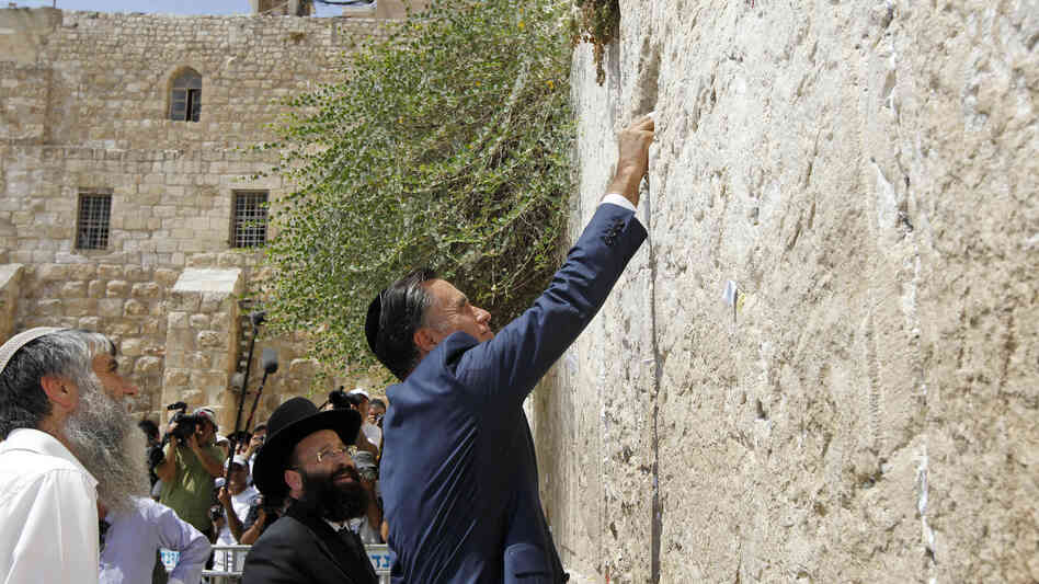 Republican presidential candidate Mitt Romney places a prayer note as he visits the Western Wall in Jerusalem on Sunday.