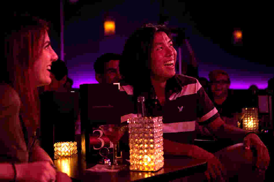 Megan Lutz, left, and Justin Chun react to Lynch's standup routine. When we laugh at a joke, Lynch hypothesizes, we are often revealing our unconscious attitudes.