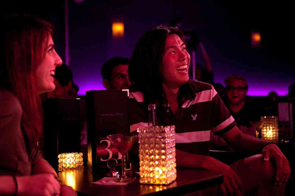 Megan Lutz, left, and Justin Chun react to Lynch's standup routine. When we laugh at a joke, Lynch hypothesizes, we are often revealing our unconscious attitudes.