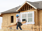 A construction worker carries lumber while working on new homes in San Mateo, Calif., in March. Homebuilding is at its highest level in nearly four years. A construction worker carries lumber while working on new homes in San Mateo, Calif., in March. Homebuilding is at its highest level in nearly four years.