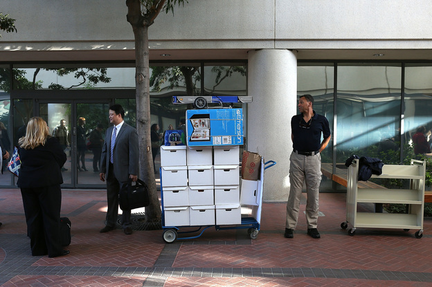 Samsung Electronics Co. representatives wait to enter the Robert F. Peckham Federal Courthouse in San Jose, California on Monday.