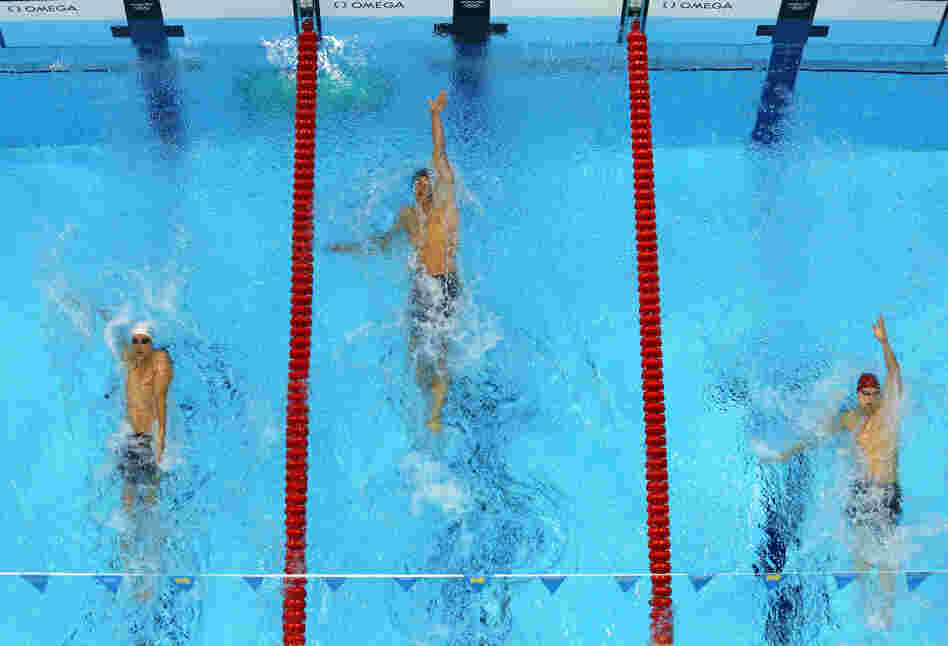 U.S. swimmer Matt Grevers (center) won the men's 100m backstroke final. 
