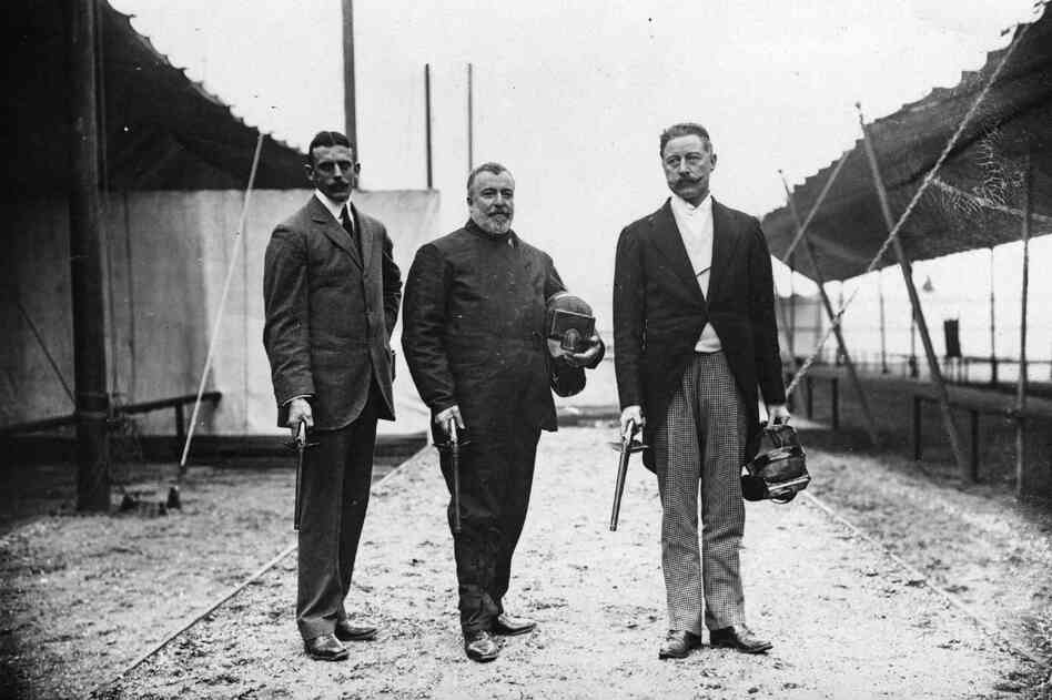 Members of the British fencing team with dueling pistols, which had been an event in 1906. Sir Cosmo Duff Gordon (right) would, a few years later, survive the sinking of the Titanic.