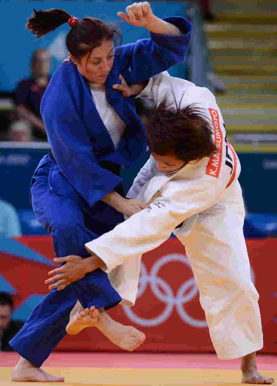 Japan's Kaori Matsumoto (white) competes with Romania's Corina Caprioriu during the women's 57kg judo finals. Matsumoto won the match. 