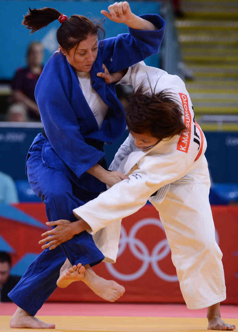 Japan's Kaori Matsumoto (white) competes with Romania's Corina Caprioriu during the women's 57kg judo finals. Matsumoto won the match. 