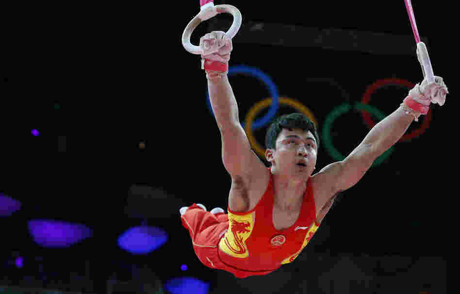 Feng Zhe of China competes on the rings during the men's artistic gymnastics finals. 