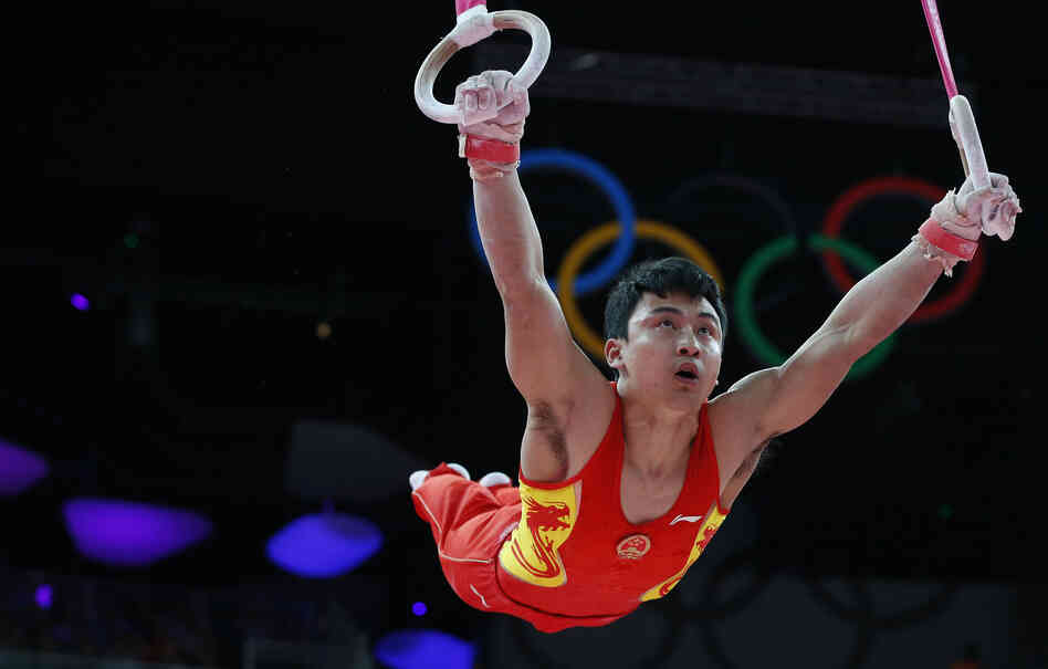 Feng Zhe of China competes on the rings during the men's artistic gymnastics finals. 