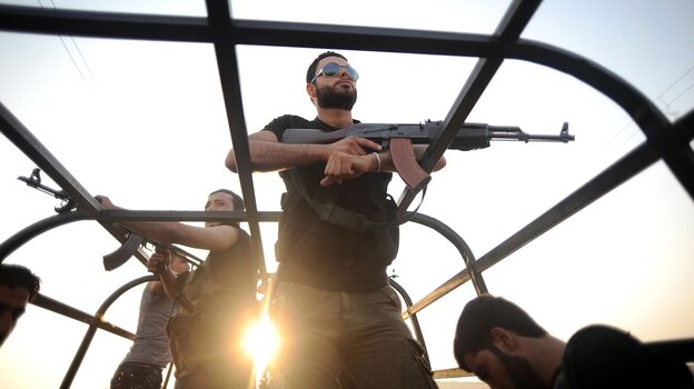 Syrian rebels patrol the streets near Aleppo, Syria.